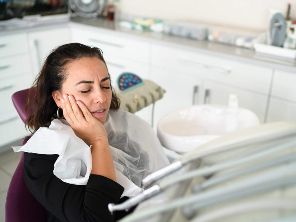 woman experiencing tooth pain