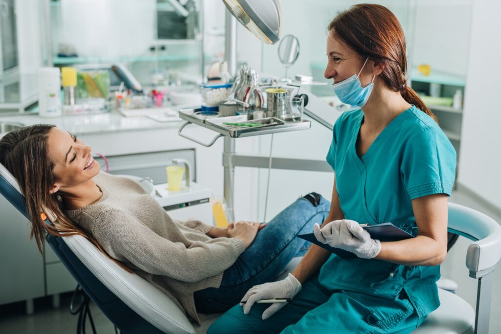 Patient speaking to dental hygienist during dental appointment