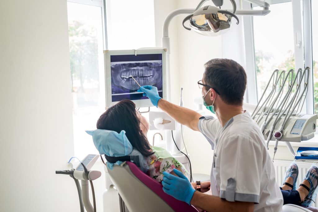 Dentist pointing at dental x-ray